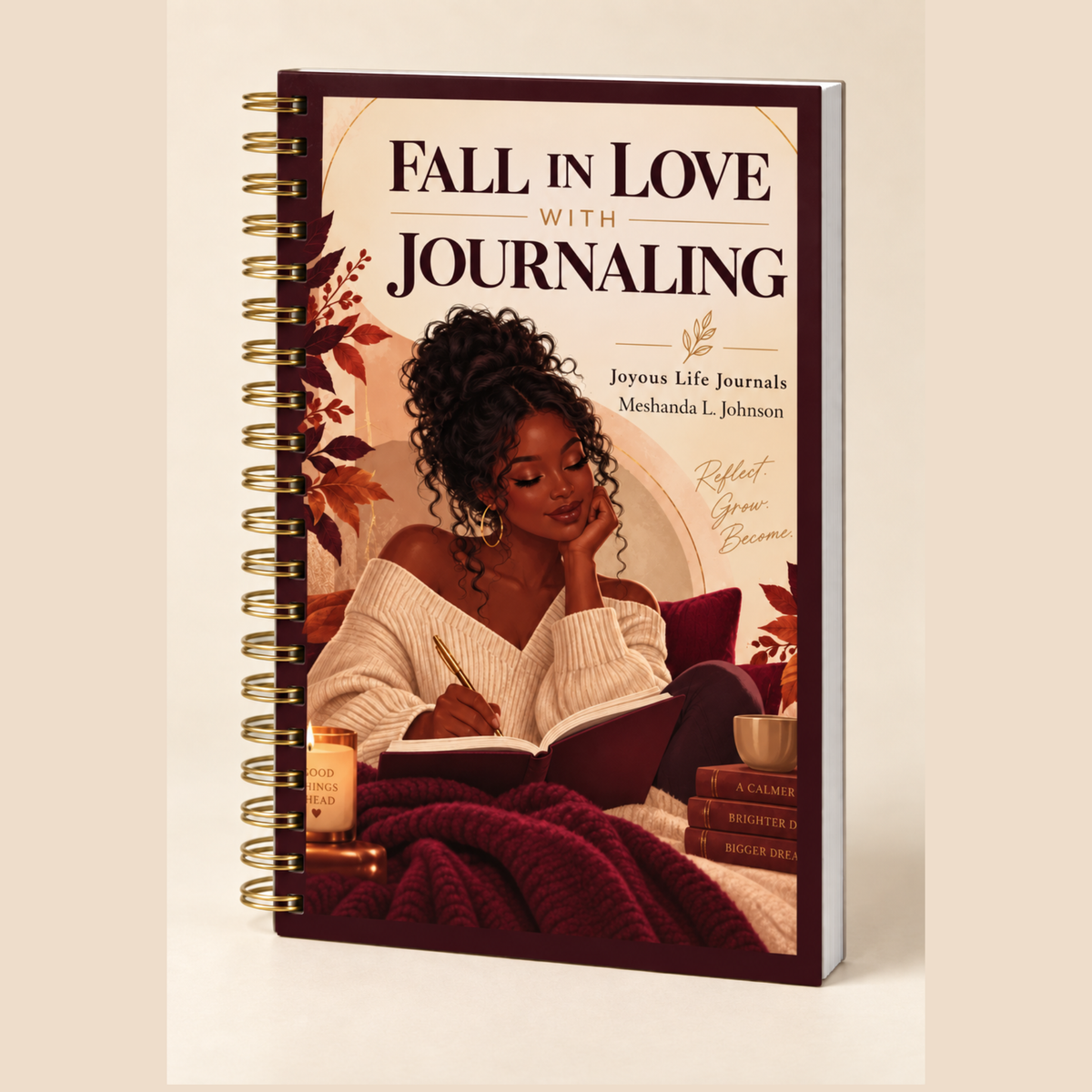 A spiral-bound journal titled 'Fall in Love with Journaling' shown upright on a plain beige background. The cover features an illustration of a woman reading under a blanket, with autumn leaves and warm-toned decor.
