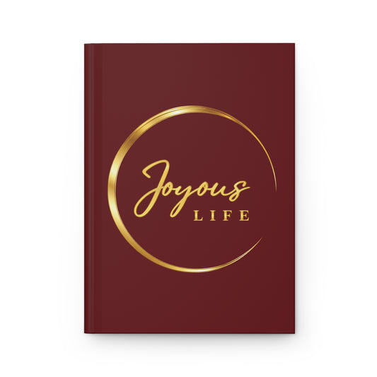 Joyous Life Signature hardcover journal with a burgundy cover and gold-look circular Joyous Life logo.